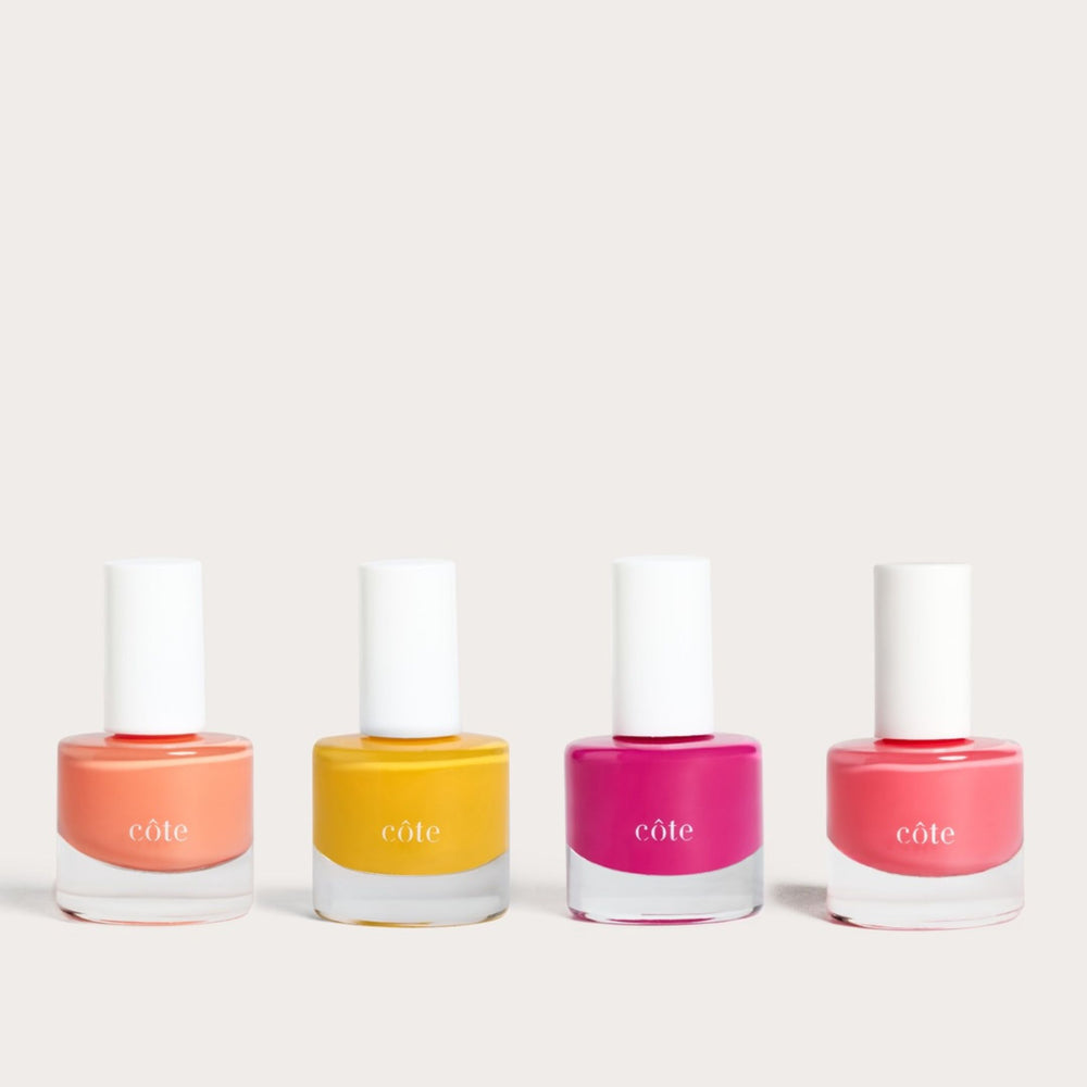 Côte Beauty Golden Hour 4-piece nail polish set with Coral Reef, Songbird, Velvet Rose and Marrakesh Sunrise on a neutral background. 
